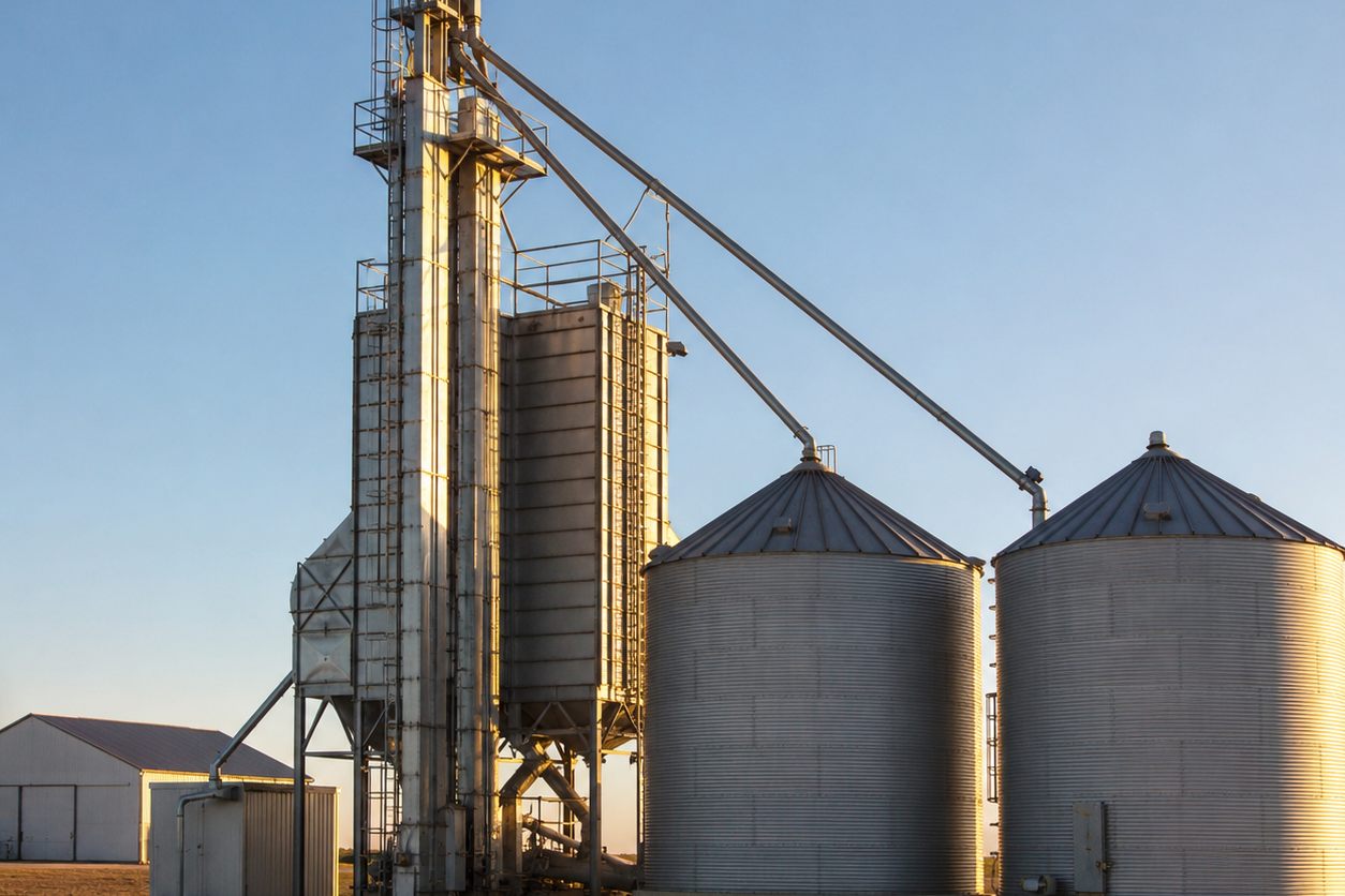 Grain bins and bucket elevator spouting at a farm grain facility